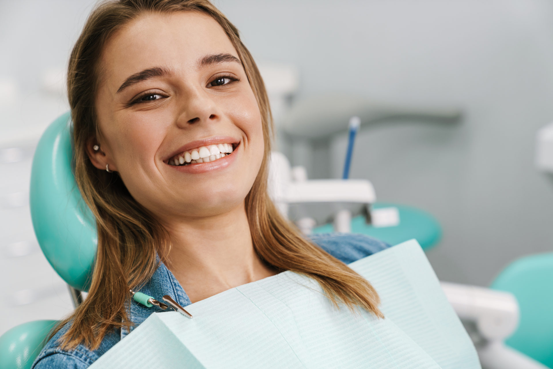 European Young Woman Smiling While Sitting In Medical Chair European young woman smiling while sitting in medical chair at dental clinic